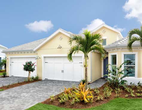 Two couples resting after playing pickleball at The Isles of Collier Preserve. New homes for sale in Naples, Florida by Minto Communities.
